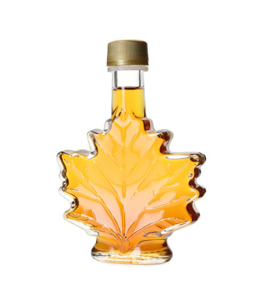 istock Leaf shaped bottle of delicious maple syrup isolated on white 1414040044