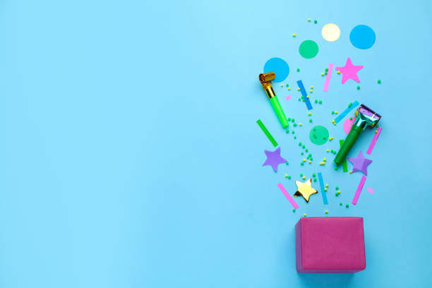 istock Party horns, confetti and box on light blue background, flat lay. Space for text 1414040302