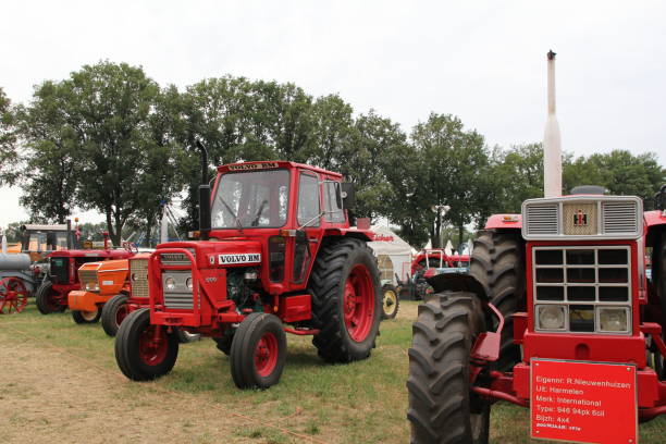Panningen, Holland - jul 31, 2022: a classic red volvo bm tractor in a row at a field at a historic farm event in Holland in summer