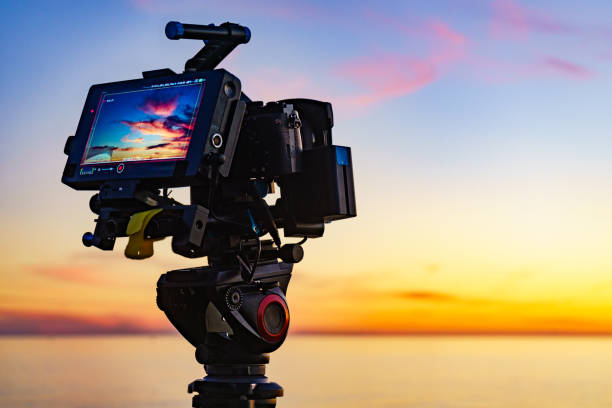 istock Camera taking picture of sunset over sea 1414041587