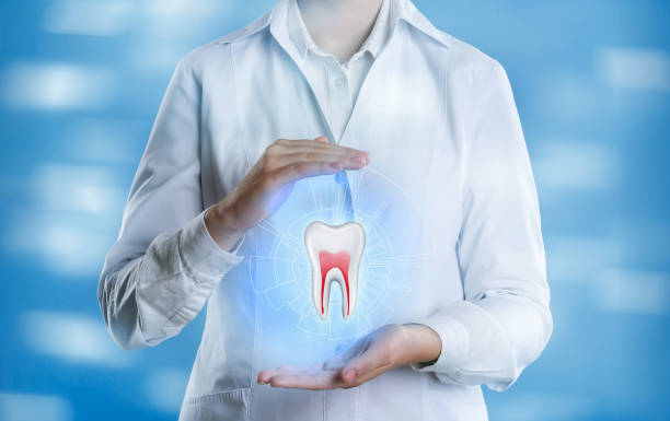 istock Dentist showing virtual model of tooth on light blue background, closeup 1414042398