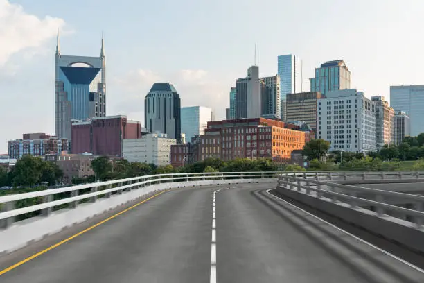 Photo of Empty urban asphalt road exterior with city buildings background. New modern highway concrete construction. Concept of way to success. Transportation logistic industry fast delivery. Nashville. USA.