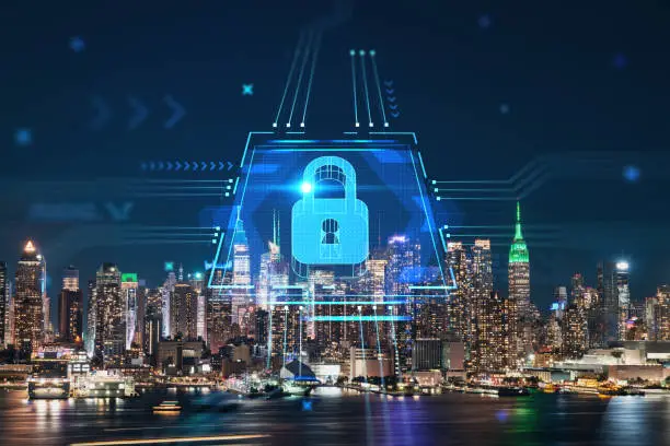 Photo of New York City skyline from New Jersey over the Hudson River with the skyscrapers at night, Manhattan, Midtown, USA. The concept of cyber security to protect confidential information, padlock hologram