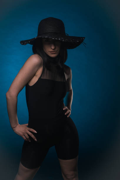 istock Elegant woman is posing with hat 1414044088