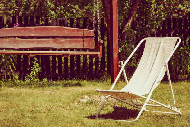 istock Garden with deck chair and swing 1414044529