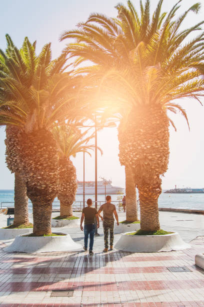 istock handsome young couple strolling through beach town 1414046809
