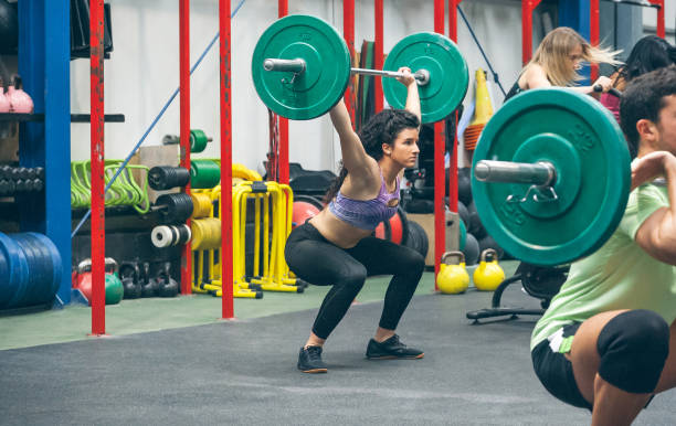 istock Woman practicing weightlifting in the gym 1414047636