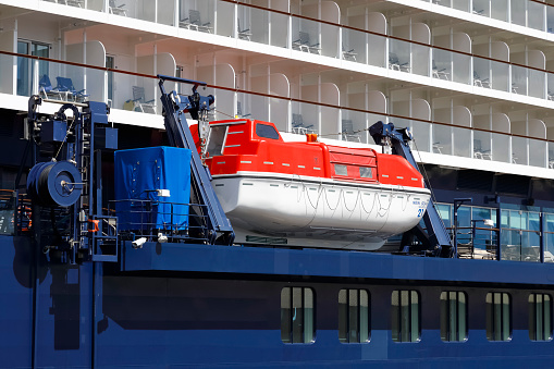 Gdynia, Poland - May 27, 2022: Lifeboat on the side of a cruise ship named Mein Schiff 1. This modern ship was put into operation in 2018 and its length is almost 316 meters.