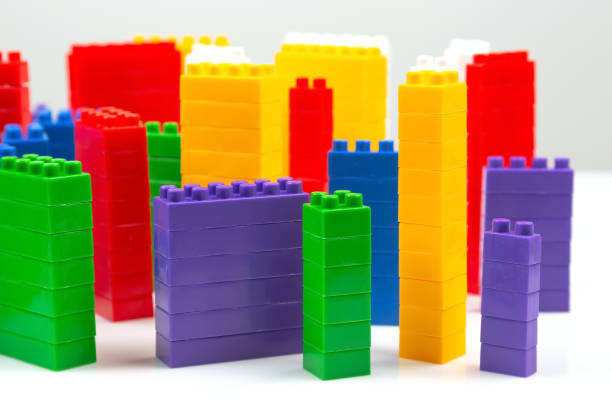 istock colored blocks of a plastic constructor on a white background in the form of multi-storey buildings. concept of modern buildings and houses 1414050232