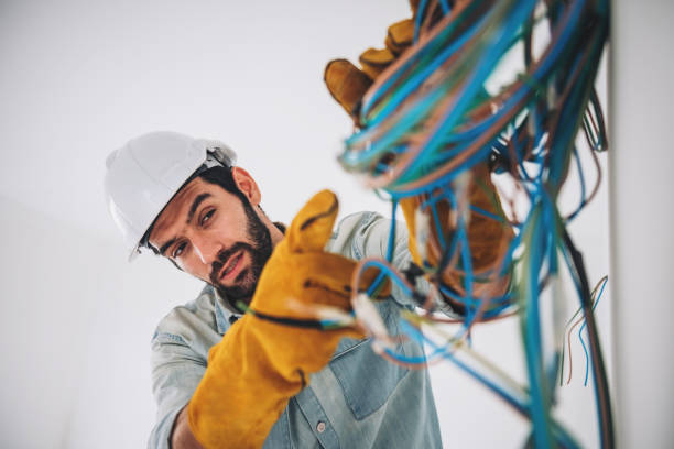 istock Portrait of caucasian man electrical engineering construction worker wearing hardhat and safety equipment, checking electrical system at construction site. 1414051073
