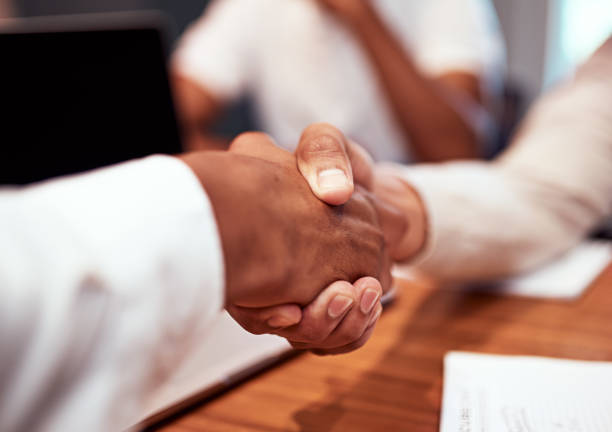 istock A handshake showing teamwork, working together and collaboration between a colleague and coworker during a business meeting in the office boardroom. A partnership and merger in trust for work success 1414051394