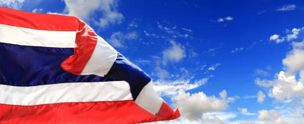istock Close up Thai flag at flagpole over sunny blue sky 1414051881