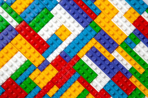 Abstract background texture of colored constructor blocks. Background of colorful plastic part of constructor. Pile of colored toy bricks.