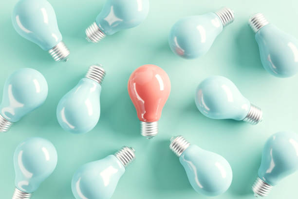 istock Minimal idea of pink light bulb surrounded with blue bulbs on pastel background. 3d rendering. Idea creative Concept. Copy space. 1414053148
