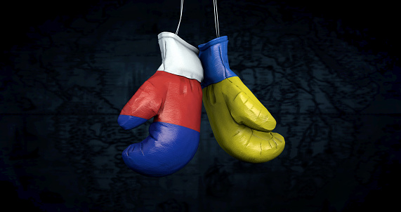 Hanging boxing gloves with the Russian and Ukrainian flags illustrate the tensions between the two countries - 3d illustration