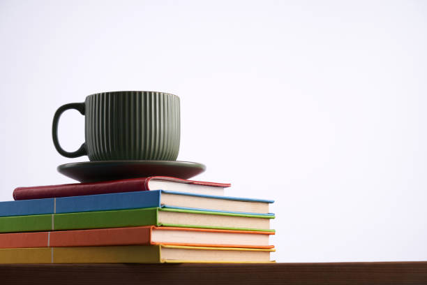 istock coffee cup on top of  stack of books 1414053691