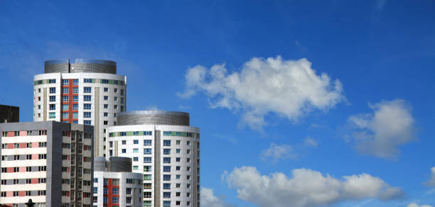 Group of residential apartment buildings in a row over sunny blue sky