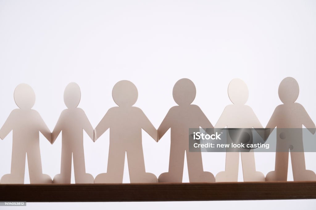 Human chain paper with light and shadow on wood table Chain - Object Stock Photo