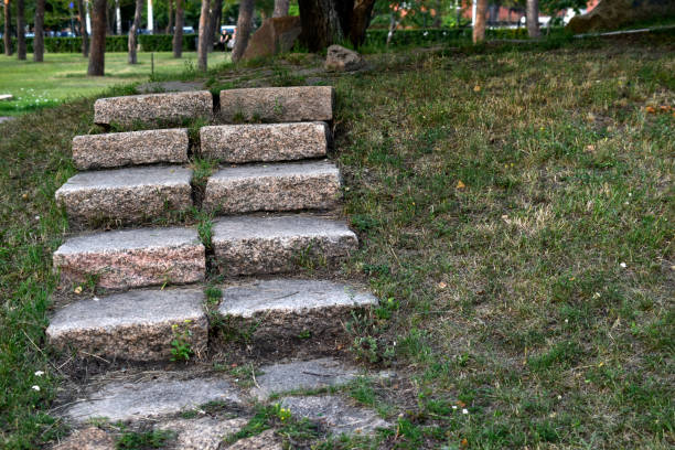 istock A stone path in the park and a granite staircase with steps. Stone steps in the garden. 1414054488