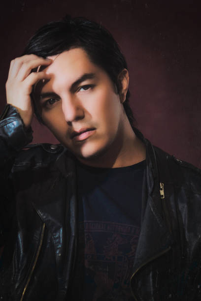 istock Long-haired young man in fur jacket 1414054586