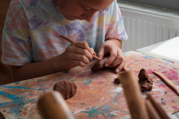 istock Children hands molding clay at home 1414055079