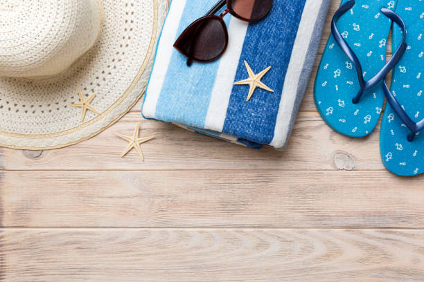 istock Summer vacation concept flat lay. straw hat beach accessories and towel top view. Space for text. travel concept 1414055507