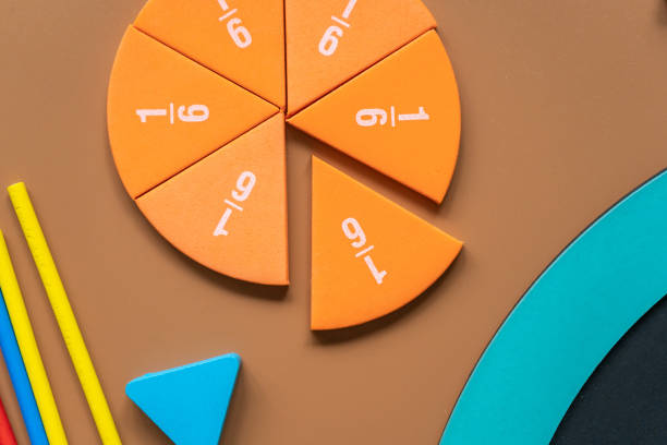 istock Closeup school board, mathematical fractions, pencils, notebook, ruler, accessories for school on brown table. Back to school, education background 1414056435