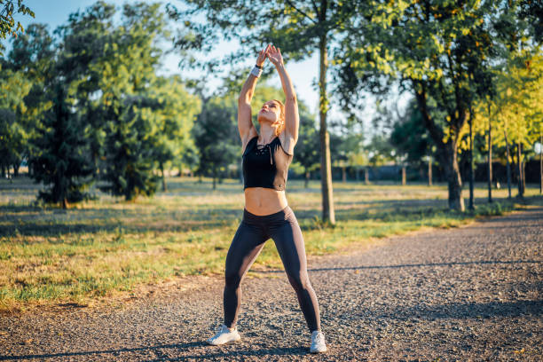 istock Woman stretching and exercising outdoor 1414056631