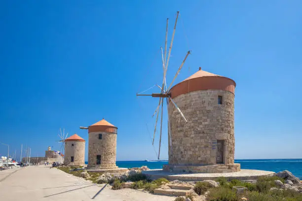 Windmills of Mandraki harbour in Rhodes town, Greece, Europe.