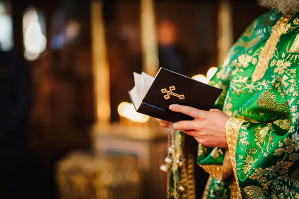 Divine Liturgy. Christian ritual. Close up photo of a priest and the Bible.