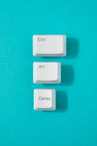 Control, alt and delete retro keys on a teal background. Reset, recession minimal concept.