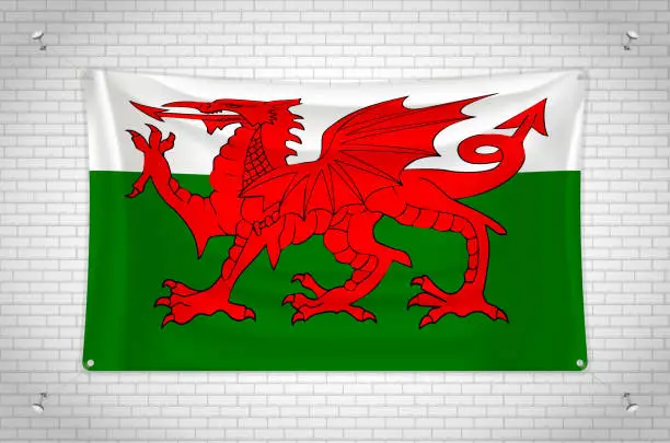 Vector illustration of Wales flag hanging on brick wall.