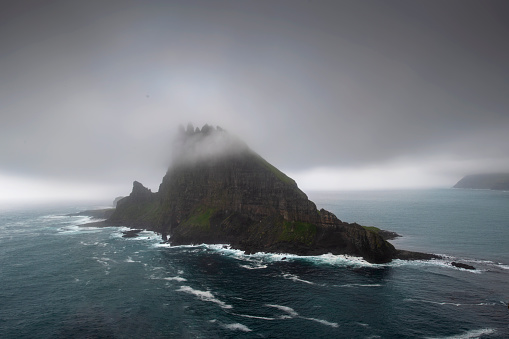 he tindholmur island with bad weather view from a cliff in Vagar - Faroe Island