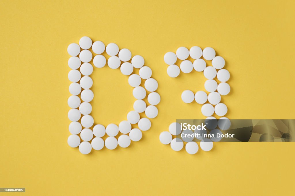 Pills of vitamin D3 on yellow background top view. Pills of vitamin D3 on yellow background top view. Concept of vitamin d3. Inscription D3. Vitamin Stock Photo