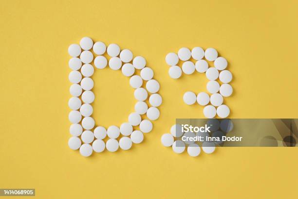 Pills Of Vitamin D3 On Yellow Background Top View Stock Photo - Download Image Now - Vitamin, Division 3, Sunlight