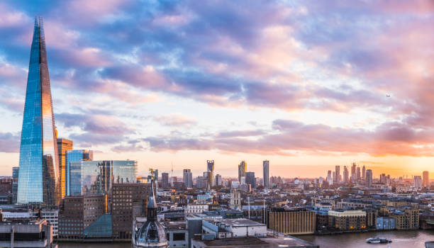 London sunset over The Shard Thames South Bank cityscape panorama The iconic spire of The Shard rising high over the rooftops of London and the River Thames at sunset. bankside photos stock pictures, royalty-free photos & images
