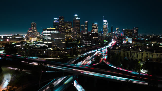 Panning Hyper Lapse of Freeway Interchange and Downtown LA Skyline at Night