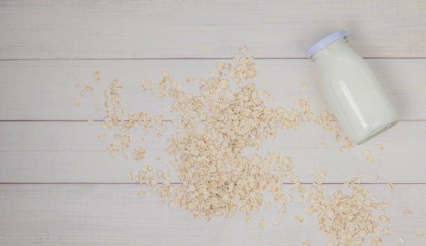istock Oat flakes and oat milk in a glass bottle 1414078096