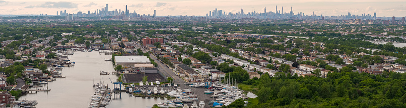 Manhattan over Brooklyn distant view, East Mill Bassin at the front with many yachts and boats. Neighborhoods Old Mill Bassin, Flatlands and Bergen Beach.