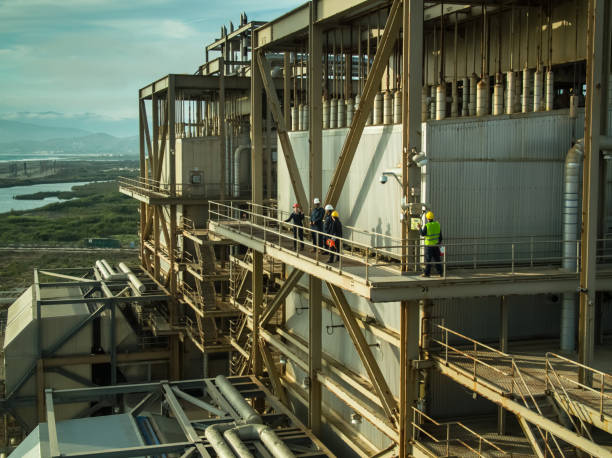 istock Power Plant Workers on External Walkaway - Drone Shot 1414081968