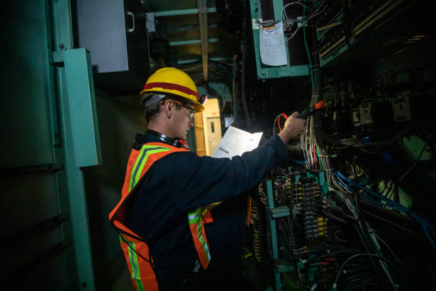istock Electrical Engineer Working at Power Plant Consulting Diagram 1414082117