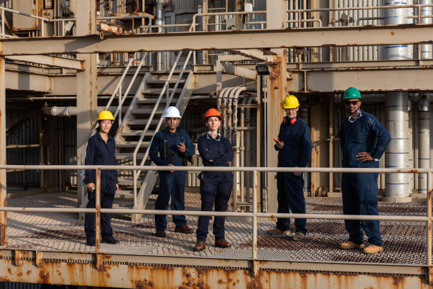 istock Power Plant Workers on Walkway Looking at Camera 1414082186