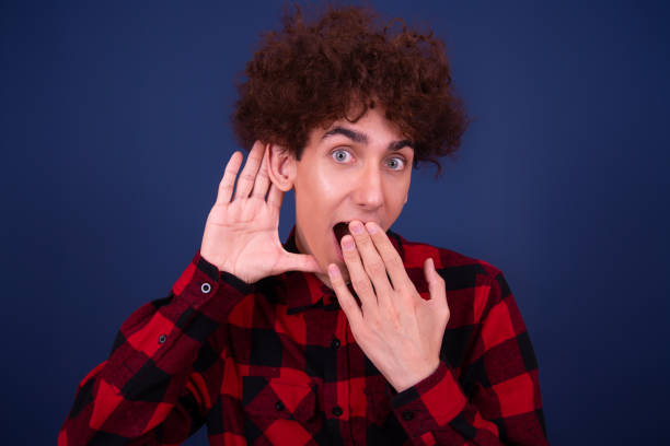 istock Emotions of a young attractive guy. Blue background. 1414082881