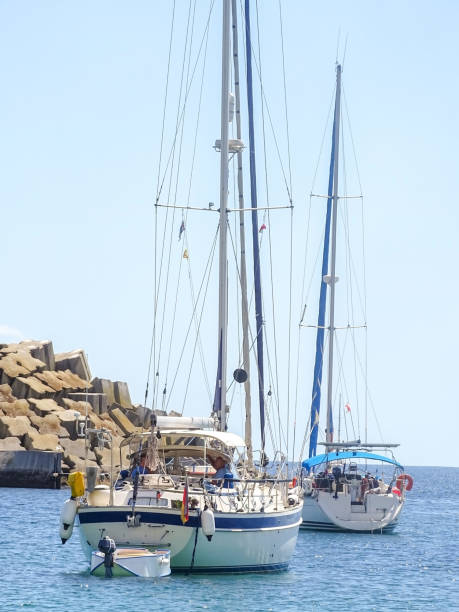 istock Two white yachts in the bay with lowered sails 1414083106