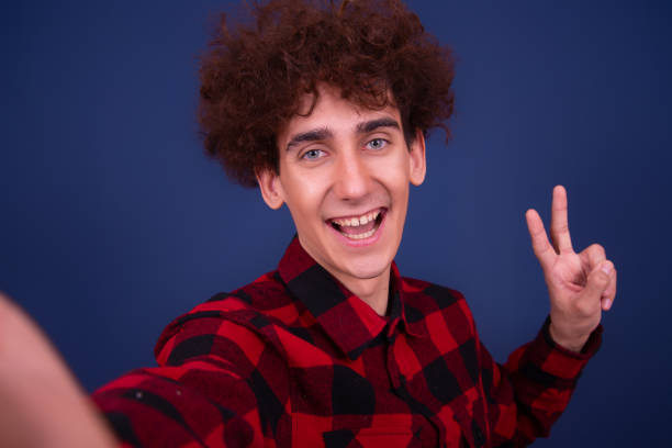 istock Emotions of a young attractive guy. Blue background. 1414083575