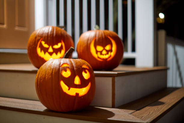 Halloween Pumpkins on a porch Halloween Jack-o'-lantern pumpkins lit insight on a porch halloween lantern stock pictures, royalty-free photos & images