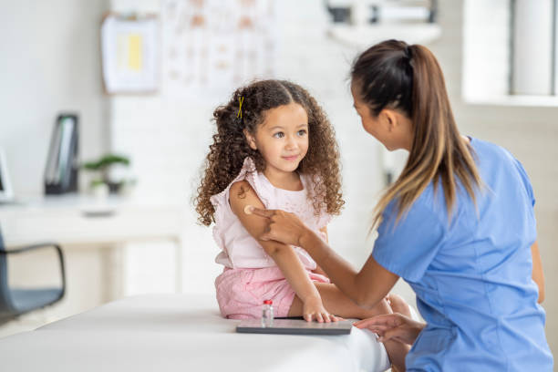 getting a bandage after an immunization - pediatrician imagens e fotografias de stock