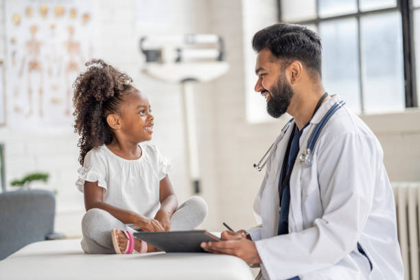 istock Doctor Seeing a Young Patient 1414087425