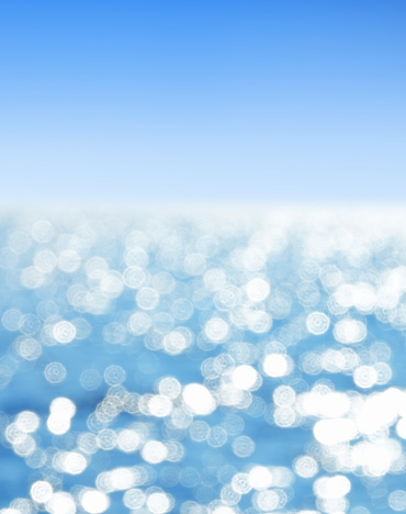Abstract seascape background with shiny sea over sunny blue sky