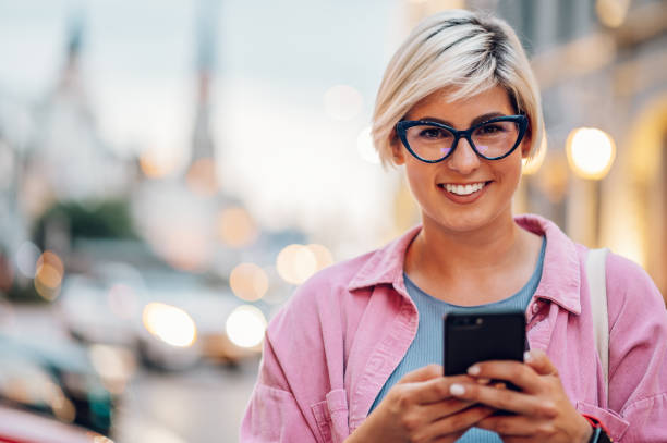 istock Young plus size woman using smartphone while walking in the city. 1414091488